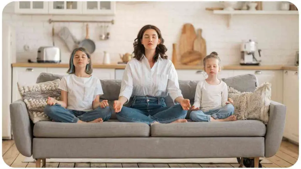 a group of individuals meditating on a couch.