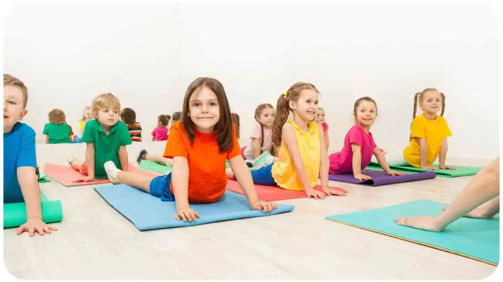 a group of individuals sitting on yoga mats in a room.