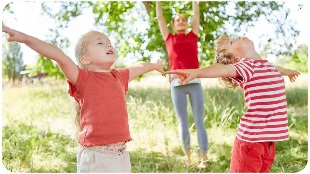 a group of people standing in the grass with their arms outstretched