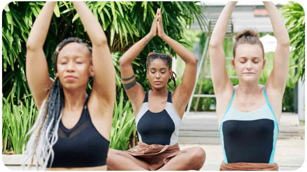 a group of people doing yoga in a park