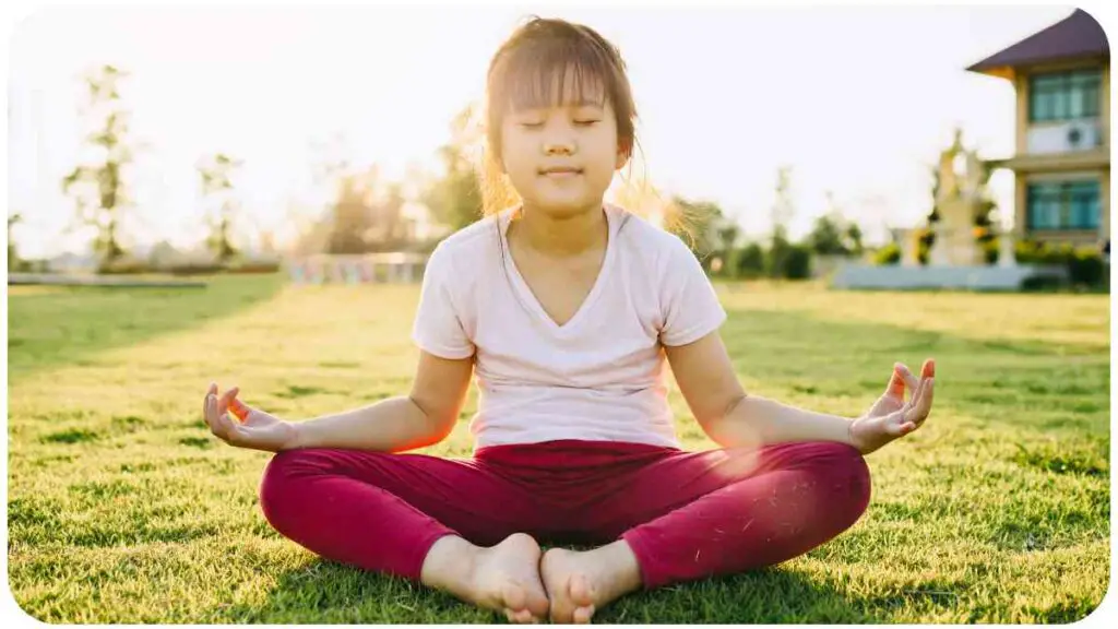 a person is sitting in the middle of a field doing yoga