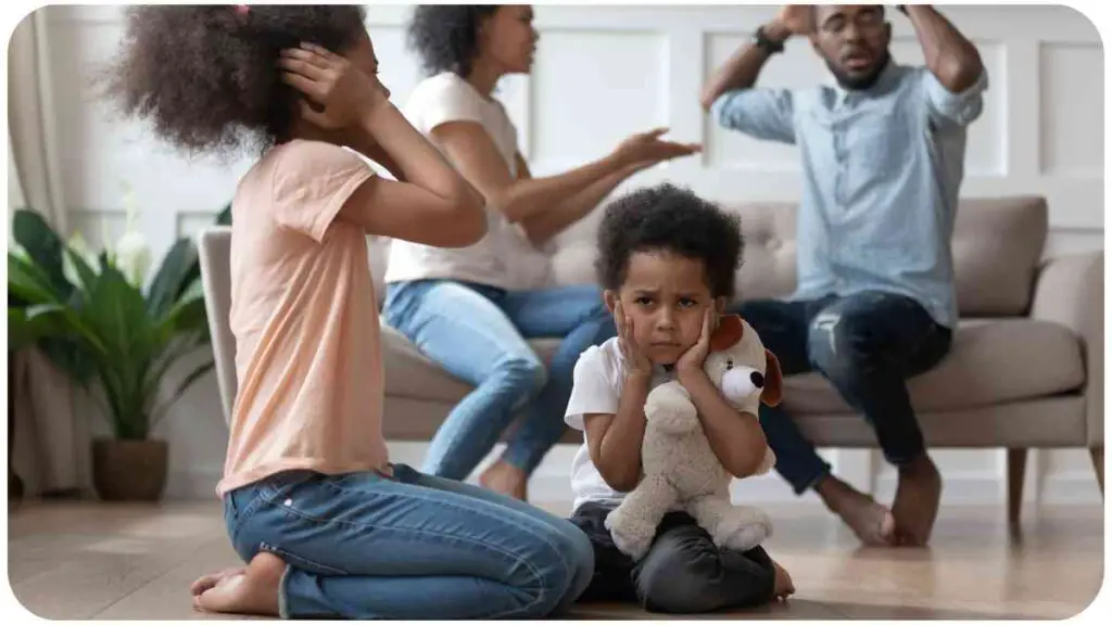 a family sitting on the floor in a living room.