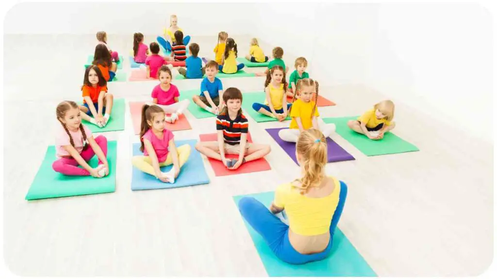 a group of people sitting on yoga mats in a room