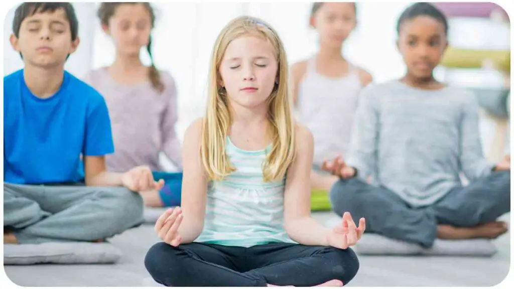 a group of individuals meditating in a yoga class.