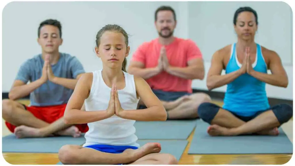 a group of people meditating in a yoga class