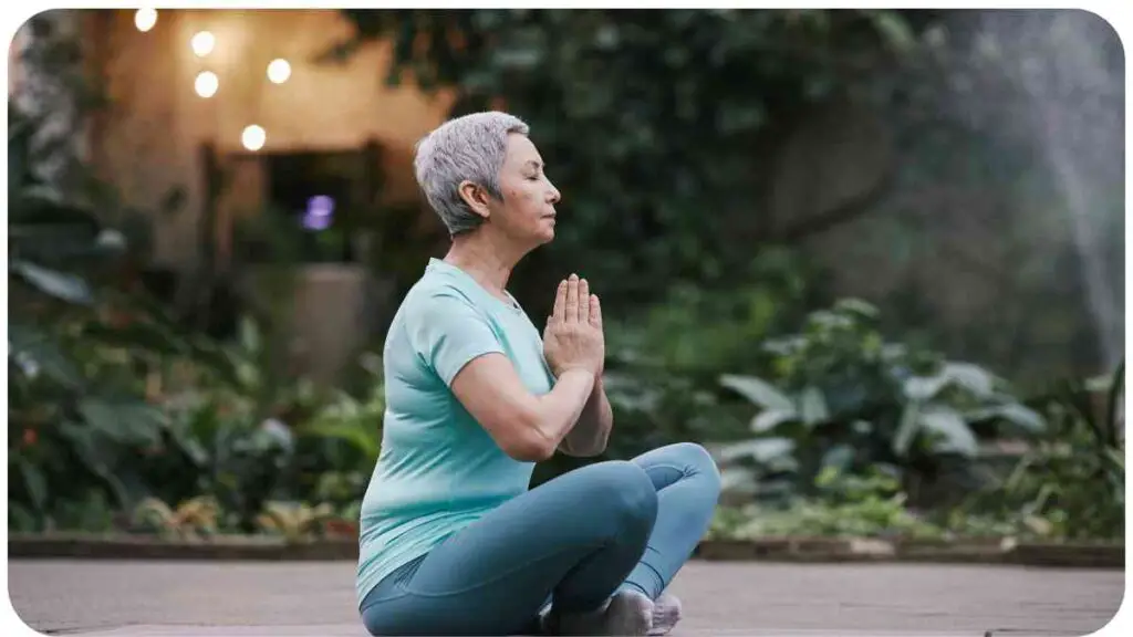 an older person is doing yoga in the garden