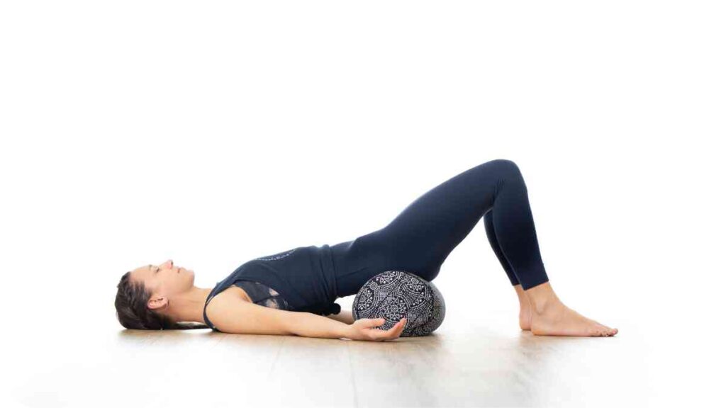 a person is doing a yoga pose on a ball