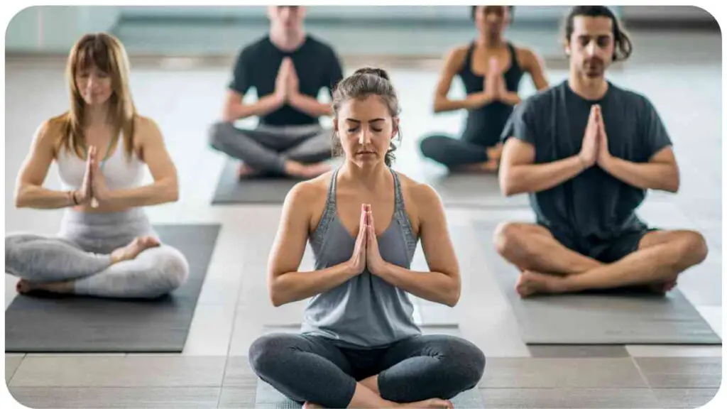 a group of people meditating in a yoga class