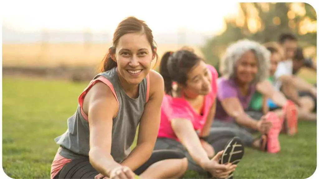 a group of people stretching on the grass