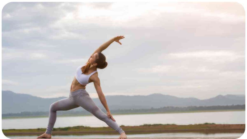 a person doing yoga in front of a body of water