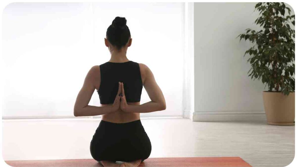 a person is sitting in the middle of a yoga pose